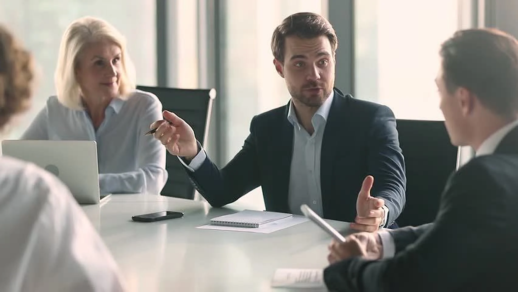Colleagues talking across a meeting table